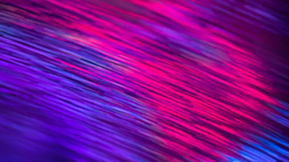 Dynamic abstract artwork with vivid pink and purple streaks creating an energetic visual effect.