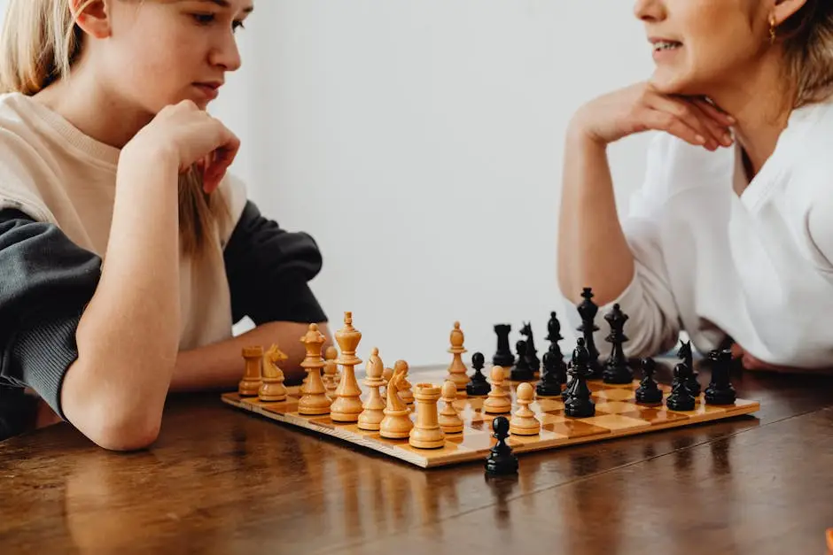 Two women thoughtfully playing chess on a wooden table, focusing on strategy.