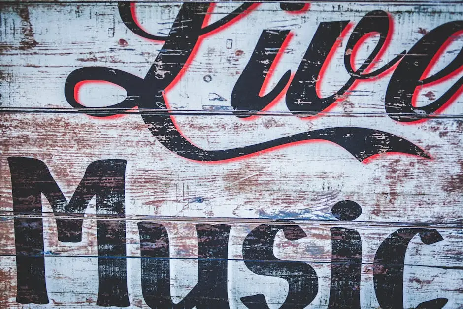 Close-up of a vintage sign reading 'Live Music' on a rustic wooden wall